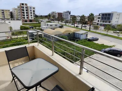a chair on a balcony with a view of a city at Big Blue Apartment in Ulcinj