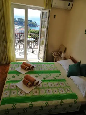 a bedroom with a large bed with towels on it at Apartment Olimp Ulcinj in Ulcinj