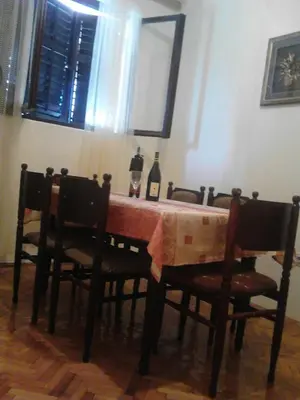 a dining room table with two bottles of wine on it at Apartment Olimp Ulcinj in Ulcinj