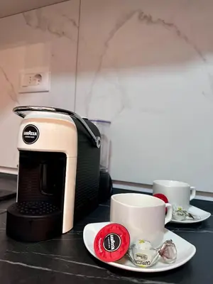 a toaster and two cups on a table at Diamond apartment in Podgorica