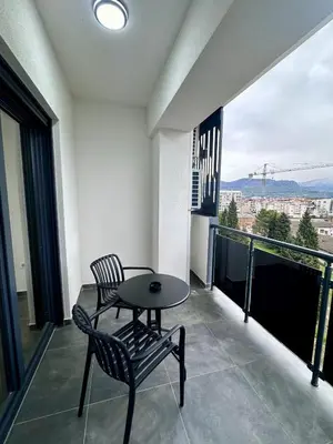 a balcony with a table and chairs and a view at Diamond apartment in Podgorica