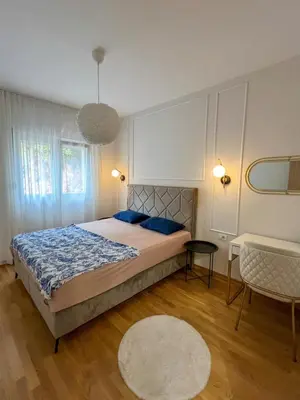 a bedroom with a large bed with blue pillows at Luxury apartment with garage in Old bakery in Budva