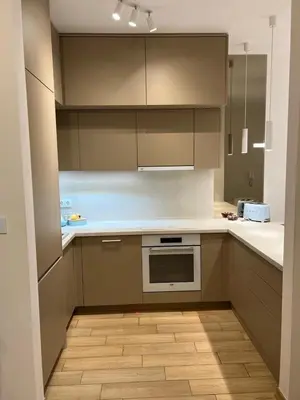 a kitchen with white counters and cabinets and a stove at Luxury apartment with garage in Old bakery in Budva