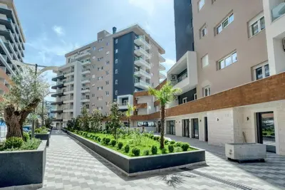 a courtyard in a building with palm trees and buildings at Luxury apartment with garage in Old bakery in Budva