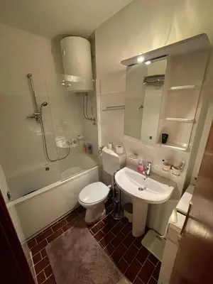 a bathroom with a toilet and a sink and a shower at Apartman Darija in Bar