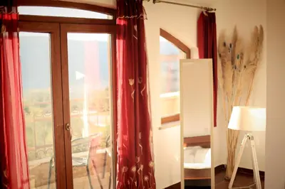 a room with a window with red curtains at Mountain View Villa in Budva