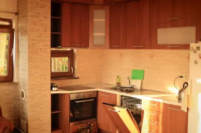 a kitchen with wooden cabinets and a stove top oven at Mountain View Villa in Budva
