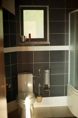 a bathroom with a toilet and a window at Mountain View Villa in Budva