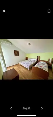 two beds in a room with wooden floors at Njaro del Mar 17 in Petrovac na Moru
