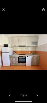 a kitchen with white cabinets and a stove top oven at Njaro del Mar 17 in Petrovac na Moru