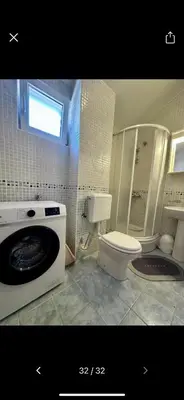 a bathroom with a washing machine and a toilet at Njaro del Mar 17 in Petrovac na Moru
