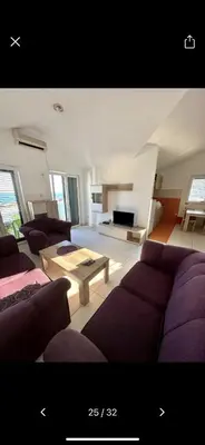 a living room with a purple couch and a table at Njaro del Mar 17 in Petrovac na Moru