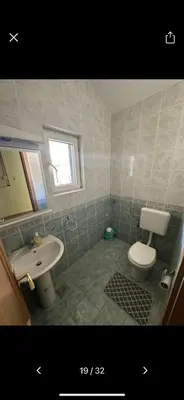a bathroom with a white toilet and a sink at Njaro del Mar 17 in Petrovac na Moru