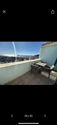 a bench on a balcony with a view of the city at Njaro del Mar 17 in Petrovac na Moru