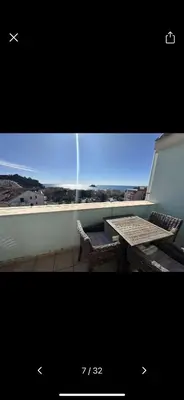 a table and chairs on a balcony with a view at Njaro Del Mar 18 in Petrovac na Moru