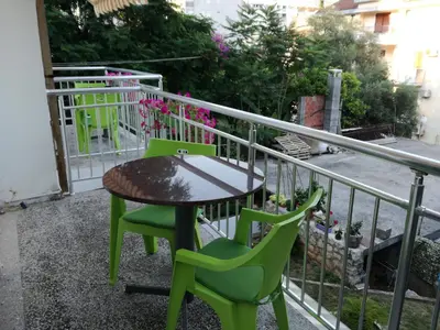 a table and two chairs on a balcony at Guest House Vila Bak in Budva