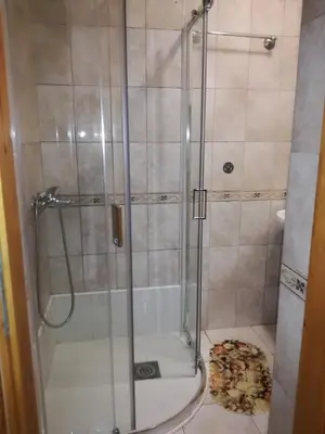 a shower with a glass door in a bathroom at Guest House Vila Bak in Budva