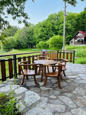 a picnic table and chairs on a stone patio at Montenegro Rustic House II in Bjeloši