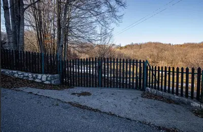 a black fence with a gate in front of it at Montenegro Rustic House II in Bjeloši