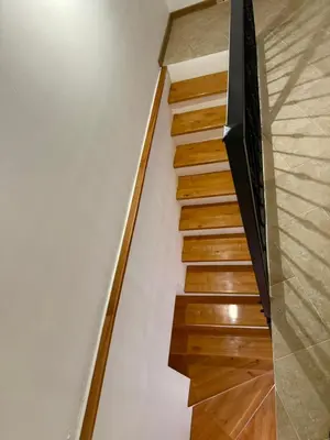 a staircase with wooden floors and a wall at Apartman Kaprize in Budva