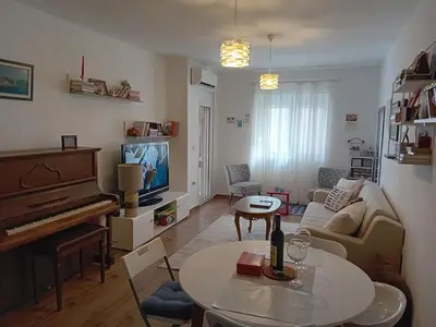 a living room with a couch and a piano at Piano Seaside in Ulcinj
