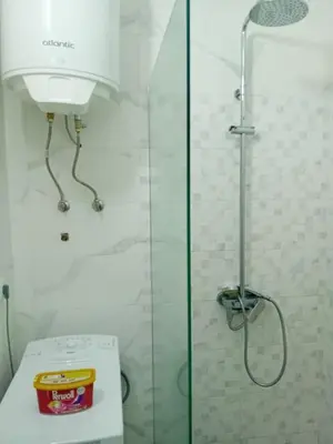 a bathroom with a shower and a toilet with a glass door at Piano Seaside in Ulcinj