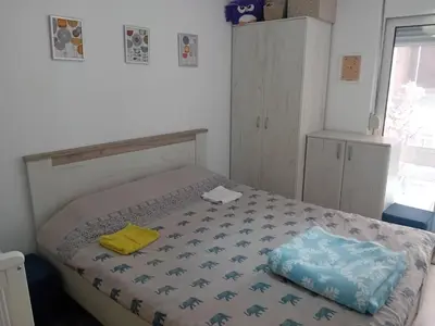 a bedroom with a bed with a pillow on it at Piano Seaside in Ulcinj