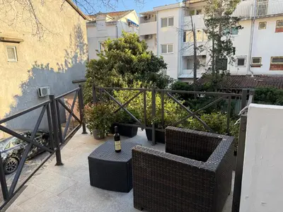 a bottle of wine sitting on top of a balcony at Bozovic Apartmani in Budva