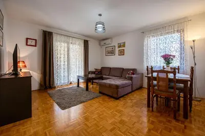 a living room with a couch and a table at Bozovic Apartmani in Budva
