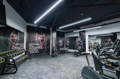 a gym with chairs and posters on the walls at Sunshine Appartement Budva in Becici