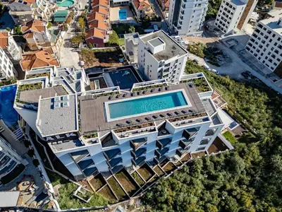 an overhead view of a building with a swimming pool at Sunshine Appartement Budva in Becici