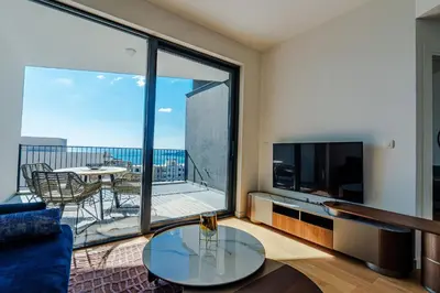 a living room with a large view of a balcony at Sunshine Appartement Budva in Becici