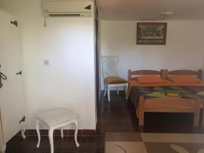 a bedroom with a bed and a table and a chair at Zagradge I.N. apartments in Sutomore
