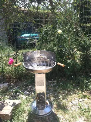 a grill sitting in the grass with at Zagradge I.N. apartments in Sutomore