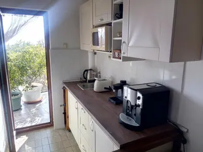 a kitchen with a counter top with a microwave and aounter at Zagradge I.N. apartments in Sutomore