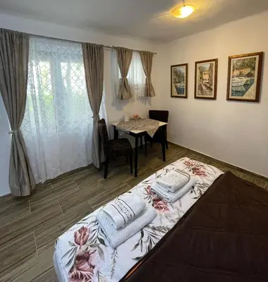 a bedroom with a bed with two pillows on it at Kotor Old Town Cozy Escape in Kotor