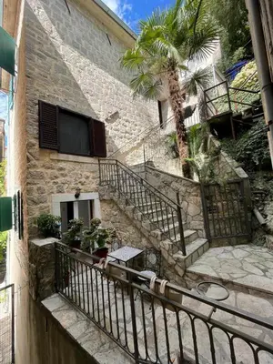 a stone building with stairs and a tv on it at Kotor Old Town Cozy Escape in Kotor
