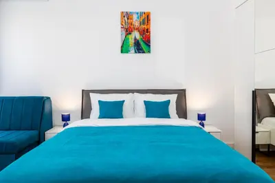 a bedroom with a blue bed and a blue chair at Sea Breeze apartment in Bar