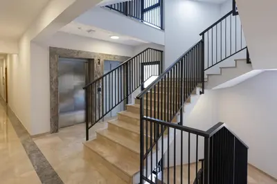 a staircase in a house with black railings at Sea Breeze apartment in Bar
