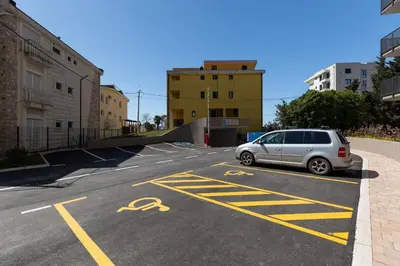 a silver car parked in a parking lot at Sea Breeze apartment in Bar