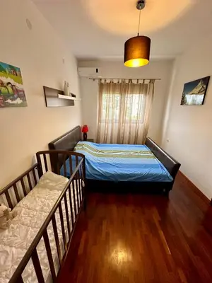 a bedroom with a bed and a couch at Velvet apartment Petrovac in Petrovac na Moru