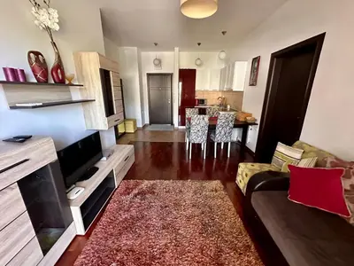a living room with a couch and a kitchen at Velvet apartment Petrovac in Petrovac na Moru