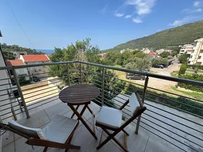a balcony with two chairs and a table at Velvet apartment Petrovac in Petrovac na Moru