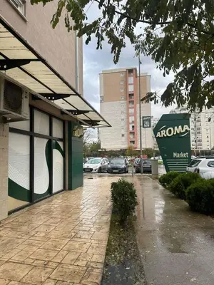 a parking lot with cars parked outside of a building at 2 bedroom apartment blok 9 in Podgorica