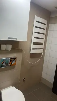 a bathroom with a white toilet and a window at 2 bedroom apartment blok 9 in Podgorica