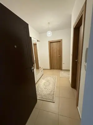 an empty hallway with a door and a rug at Stan 60m2 in Bar
