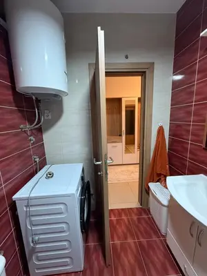 a small bathroom with a sink and a washing machine at Stan 60m2 in Bar