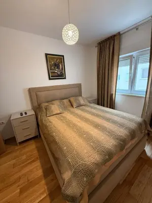 a bedroom with a bed and a window at Stan 60m2 in Bar