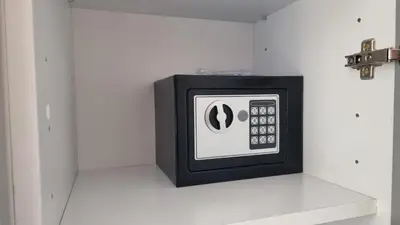 a small microwave on a white wall at Tehnoplus apartment in Budva