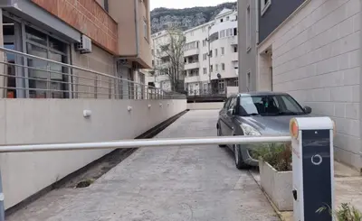 a car parked on a street next to a parking meter at Tehnoplus apartment in Budva